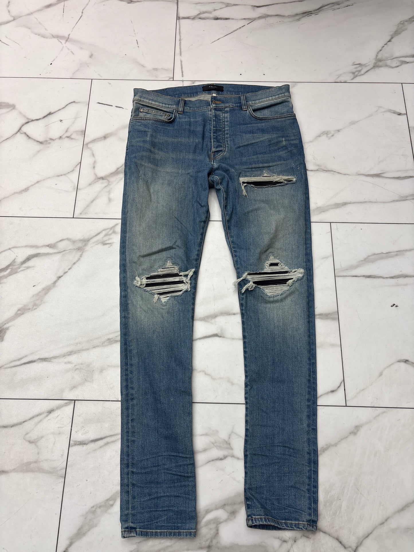Amiri MX1 Distressed Black Patch Blue Jeans