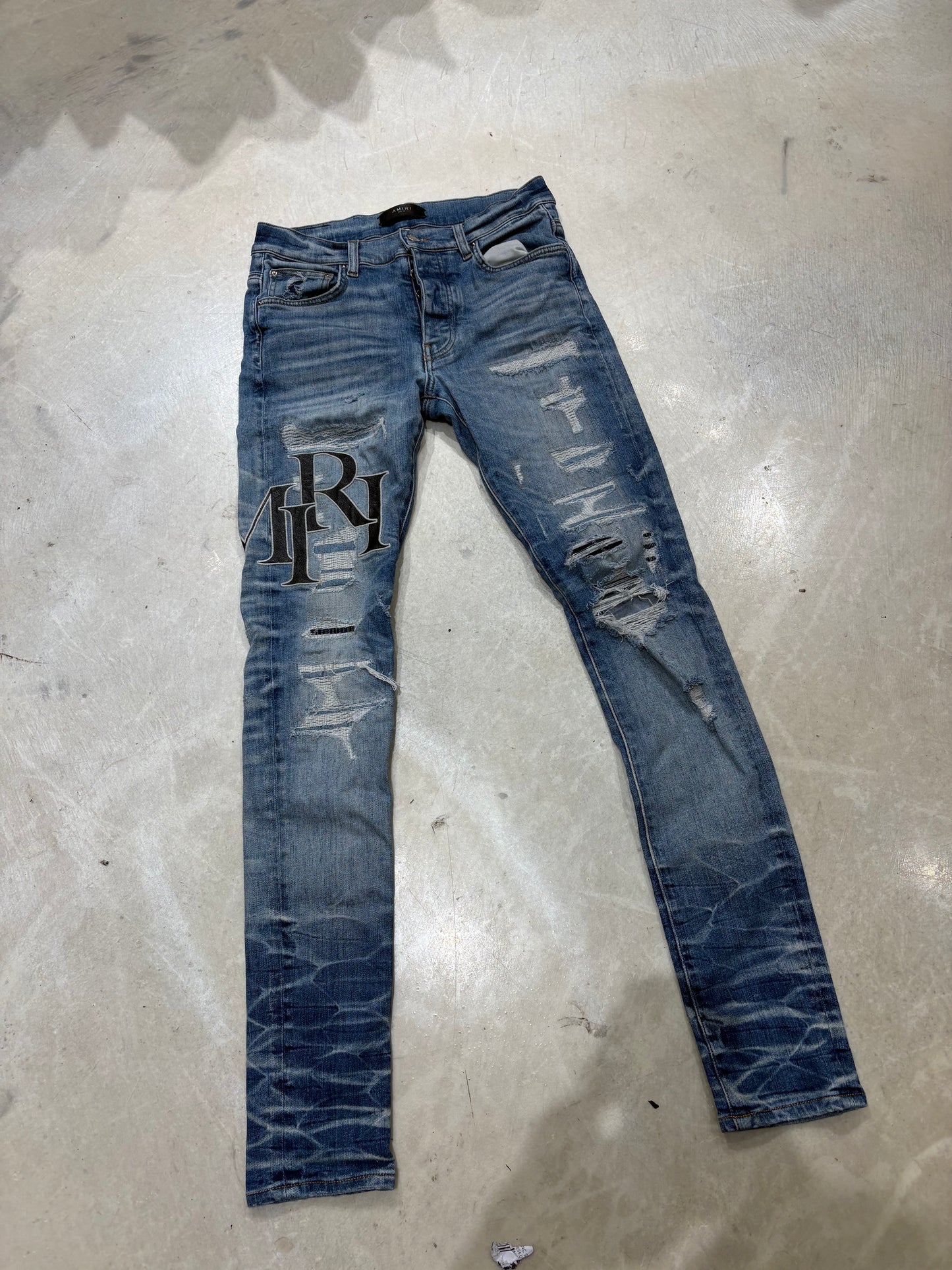 Amiri Destroyed Staggered Logo Jeans